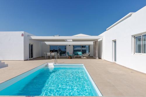 a swimming pool in the backyard of a house at Sea Sky Lanzarote in Playa Blanca