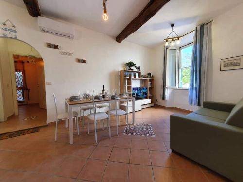a living room with a table and chairs and a couch at Casa Domitilla Vista Mare - Spiagge, Storia & Relax Wifi - Netflix in Terracina