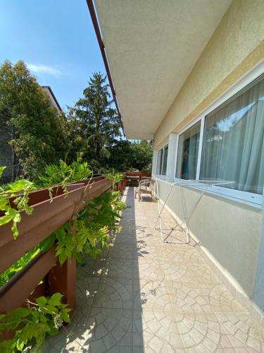 a balcony with plants on the side of a building at Villa Lux in Hévíz