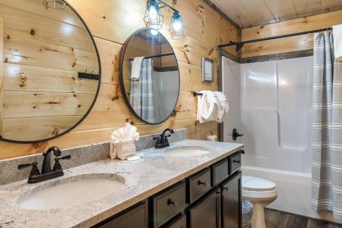 a bathroom with two sinks and a mirror at New Dollywood Hills 3 Bdrm-game room-hot tub-grill in Sevierville