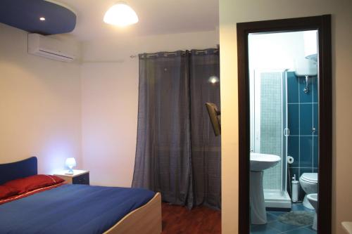 a bedroom with a bed and a bathroom with a shower at B&B Cosenza in Cosenza