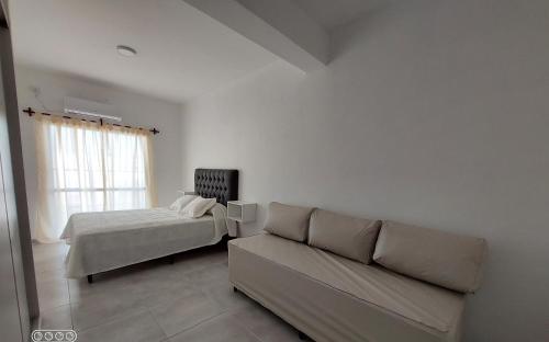 a living room with a couch and a bed at DUPLEX 3 in San Fernando del Valle de Catamarca