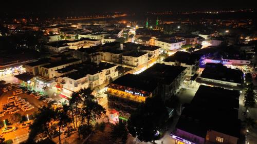 an aerial view of a city at night at Selin Otel Belek in Antalya