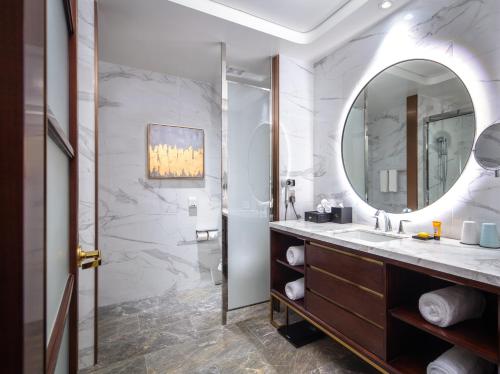 a bathroom with a sink and a mirror at Blossom Hotel Houston in Houston