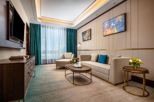 a living room with a couch and a table at Blossom Hotel Houston, Curio Collection by Hilton in Houston