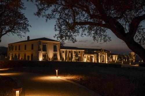 a large white house with lights in front of it at La Dehesa de Don Pedro in Monesterio