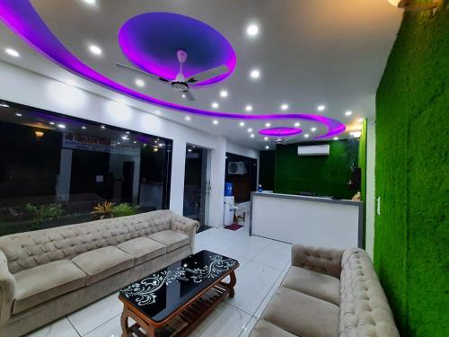 a living room with a couch and a purple ceiling at AK Residency in Haridwār