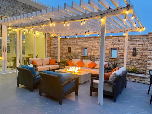 a pergola with couches and a table and chairs at Hyatt House Lewes Rehoboth Beach in Lewes