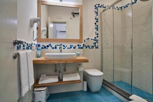 a bathroom with a toilet and a sink and a shower at il Truciolo Suite in Anacapri