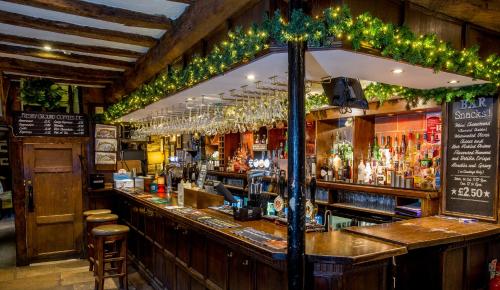 a bar with a lot of liquor bottles at The Woolly Sheep Inn in Skipton