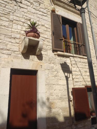 Un edificio con una planta en maceta en una ventana. en La nicchia di Mary, en Bisceglie