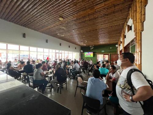 a large group of people sitting at tables in a restaurant at Hotel El Bosque in Jaén