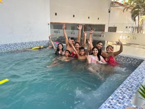 a group of people in a swimming pool at Hotel El Bosque in Jaén