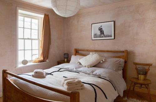 a bedroom with a bed with towels on it at The Margate Galley in Kent