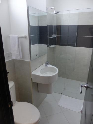 a bathroom with a toilet and a sink and a shower at Campo Godoy in Doradal