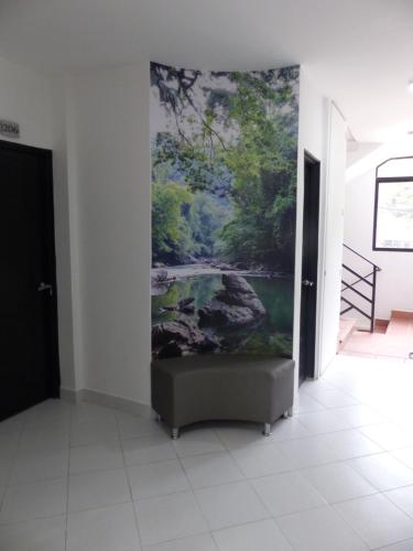 a painting on a wall in a room with a couch at Campo Godoy in Doradal