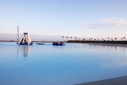 a bridge in the middle of a large body of water at Karibao Resort Town in Playas