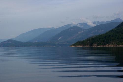 a large body of water with mountains in the background at Tranquility Bay Waterfront Inn in Sechelt