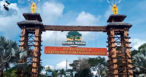 a gate at the entrance to a zoo with a sign at Campo Godoy in Doradal
