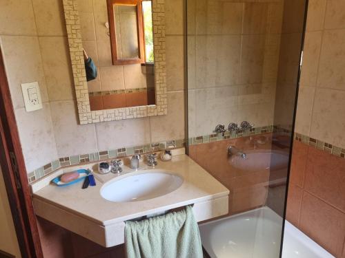 a bathroom with a sink and a shower and a tub at La Soleada in San Lorenzo