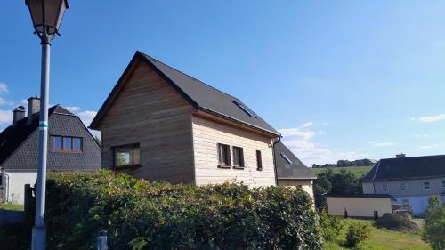 an old wooden house with a black roof at Ferienhäuser Seiffen in Seiffen