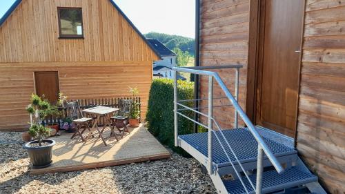 a stairway leading to a patio with a table and chairs at Ferienhäuser Seiffen in Seiffen