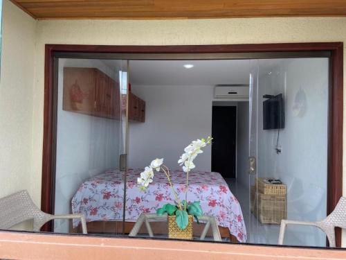 een glazen raam van een slaapkamer met een bed bij FLAT11MODULO18_MONTECASTELO in Bezerros