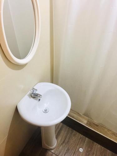 a bathroom with a white sink and a mirror at KORICANCHA in Lima
