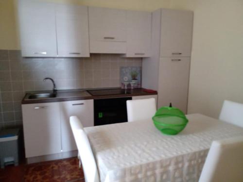 a kitchen with a table with a green bowl on it at Casa Cecilia in Gallico Marina