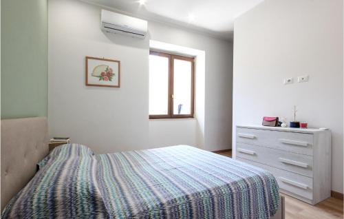 a bedroom with a bed and a dresser and a window at Nice Apartment In Sant'egidio Del M A in Corbara
