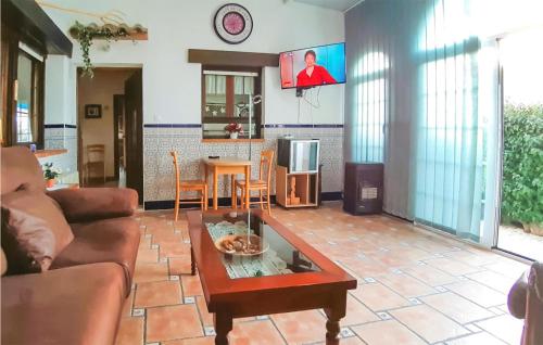 a living room with a couch and a table at Cozy Home In Rojales With Sauna in Rojales