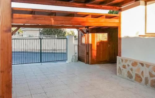an open garage with a gate and a fence at Cozy Home In Rojales With Sauna in Rojales