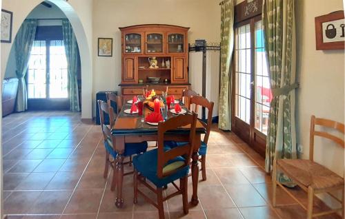a dining room with a wooden table and chairs at Cozy Home In Rojales With Sauna in Rojales