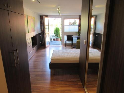 a bedroom with a bed and a living room at B&B Appartements in Tuttlingen