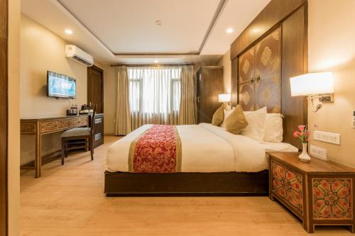 a hotel room with a bed and a desk at Himalayan Ghar in Kathmandu