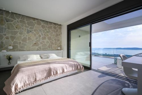 A bed or beds in a room at KOA Spa Villa-Luxury villa in Gialova with own Spa
