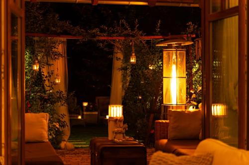 a patio at night with two chairs and lights at Spa Love Home Sauna Jacuzzi ROMANTYCZNY DOM DLA PARY in Zielona Góra