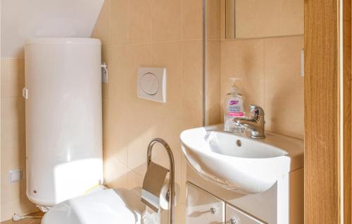 a bathroom with a toilet and a sink at Nice Home In Bialogra With Wifi in Białogóra