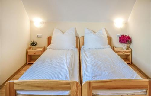 two twin beds in a room with two night stands at Amazing Home In Bialogra With Wifi And 2 Bedrooms in Białogóra