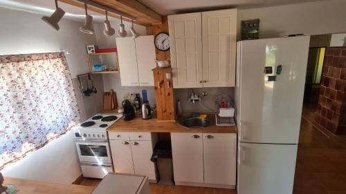 a kitchen with white cabinets and a white refrigerator at Sopot Paradise in Sopot