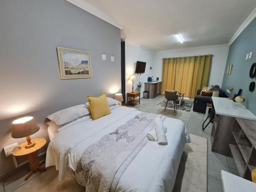 a bedroom with a large bed and a living room at the hide on 78 in East London