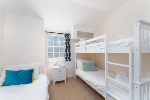 聖艾夫斯的住宿－Alba，一间卧室配有两张双层床和一张书桌