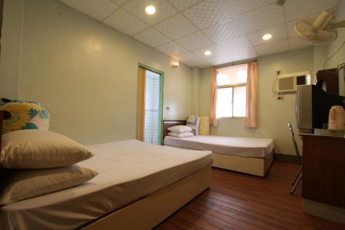 嘉義市的住宿－榮宮大飯店，酒店客房设有两张床和电视。