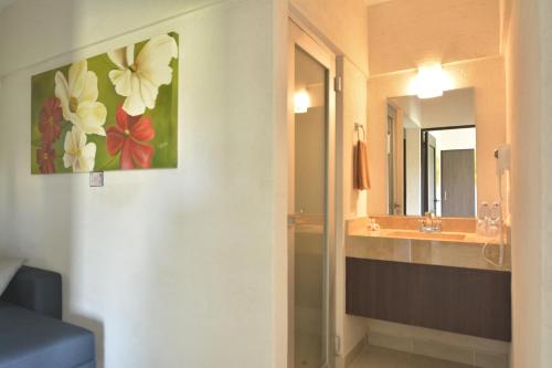 a bathroom with a sink and a mirror at Hotel Coral Cuernavaca in Temixco