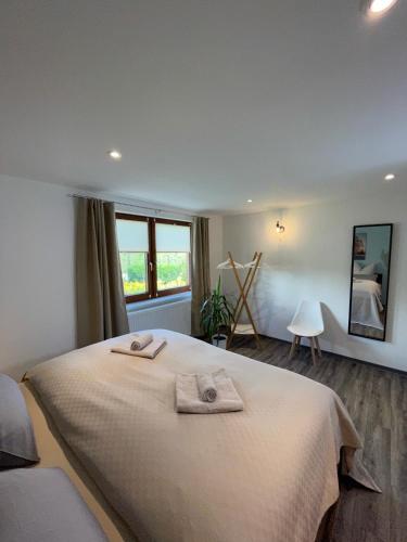 a bedroom with a bed with two towels on it at FeWo - Bergblick in Klingenthal