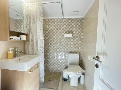 a small bathroom with a sink and a toilet at Our little 1 in Athens