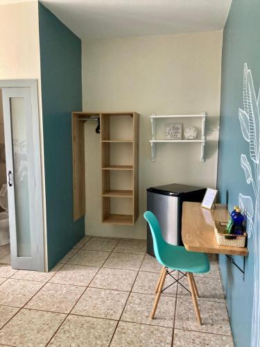 a kitchen with a table and a chair in a room at El Nido Boutique B&B in Puerto López