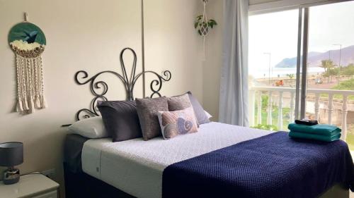 a bedroom with a bed and a large window at El Nido Boutique B&B in Puerto López