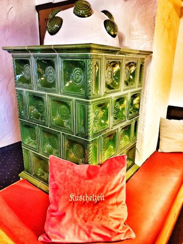 a red pillow sitting next to a green dresser at das Bergerleben in Sonnenalpe Nassfeld