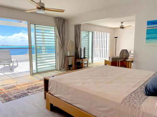 a bedroom with a bed and a view of the ocean at The View in Bora Bora